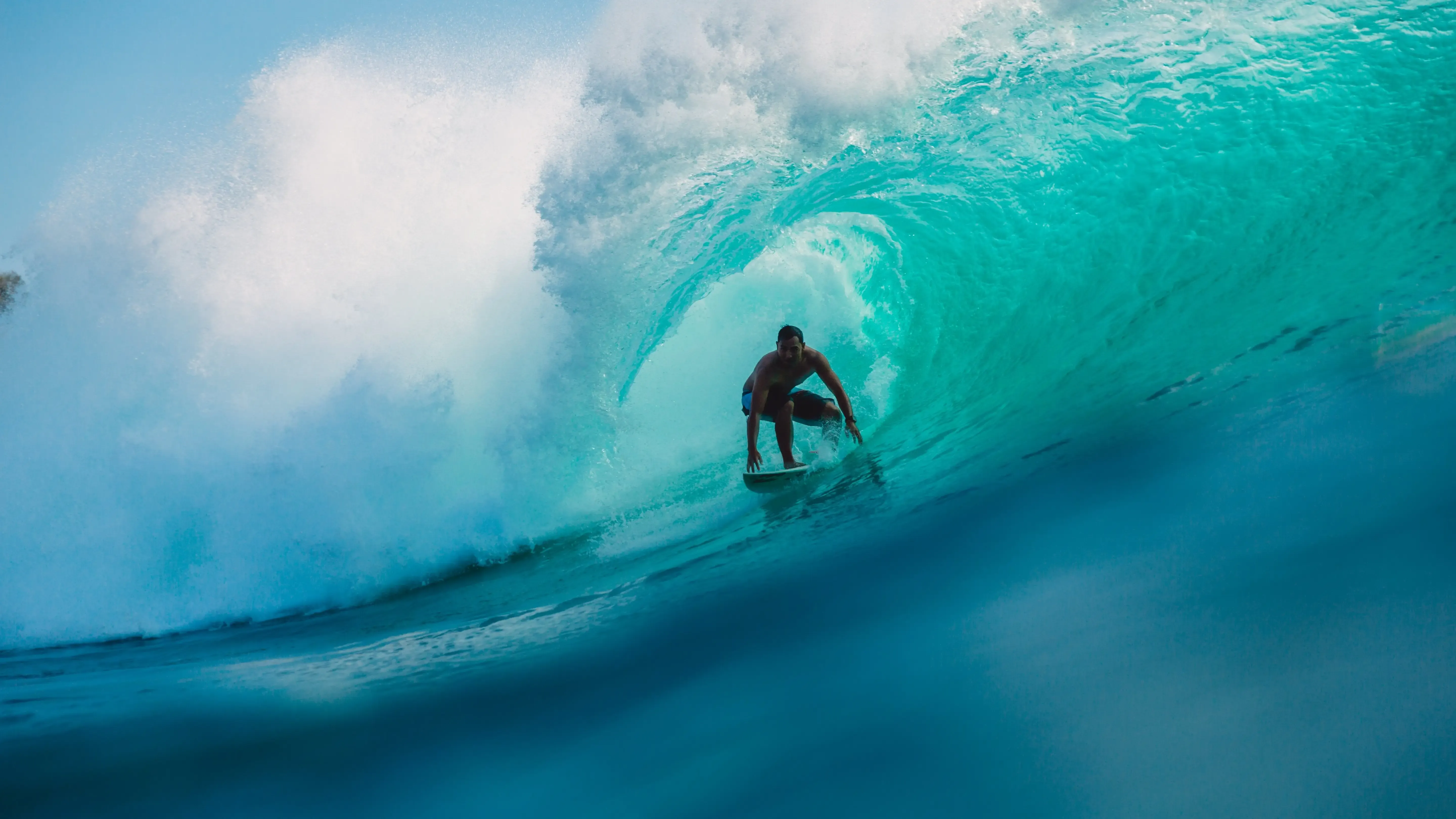 Surfer riding a powerful hollow wave on Ecuador's Pacific coast