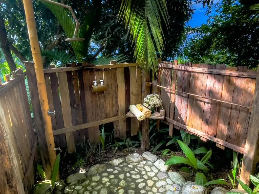 Outdoor shower surrounded by jungle at Ecuador Surf Camp in Montanita