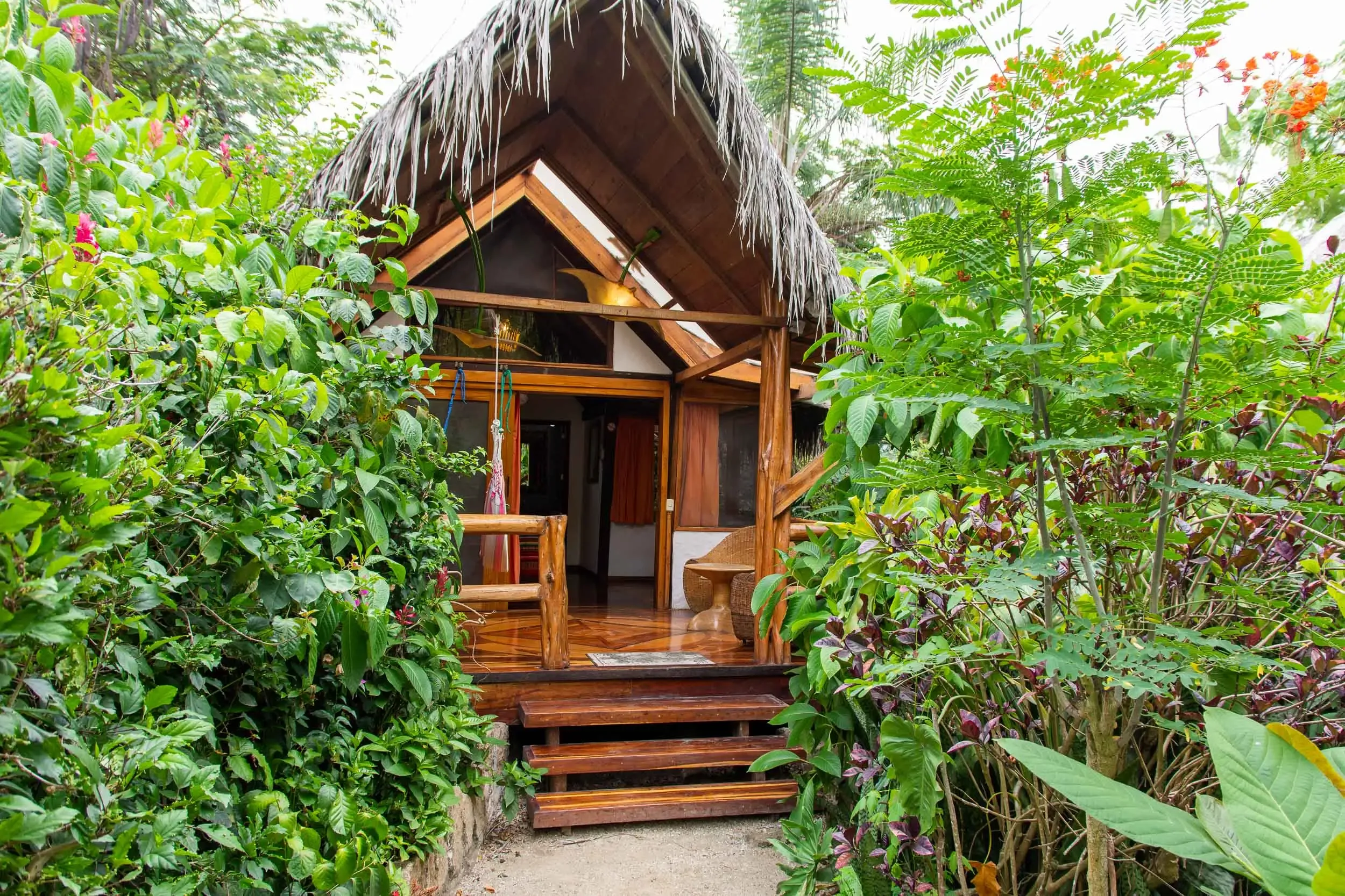 Ecuador surf resort in Montanita with tropical bungalows and the Pacific ocean in the background
